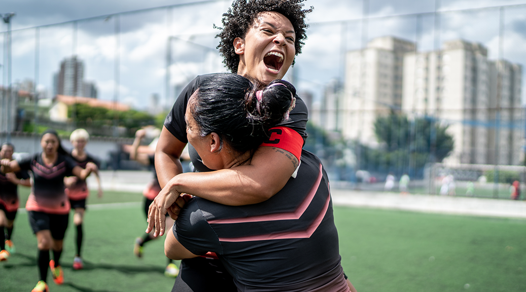 A soccer player rejoices with her team.