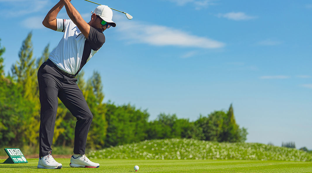 A golfer takes aim on the links.