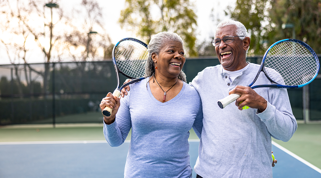 A senior couple enjoys a game of tennis together.