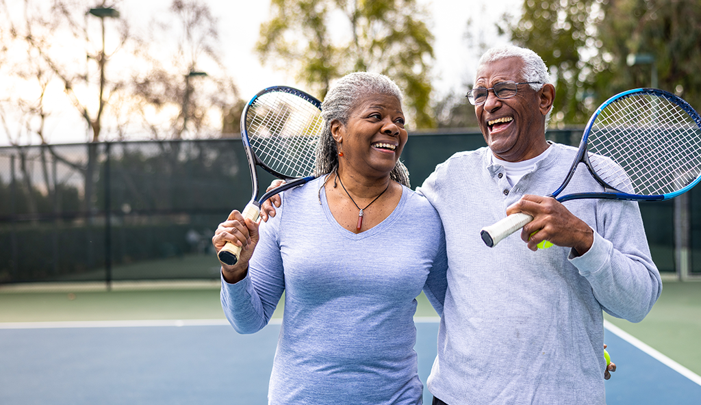 A senior couple enjoys a game of tennis together.